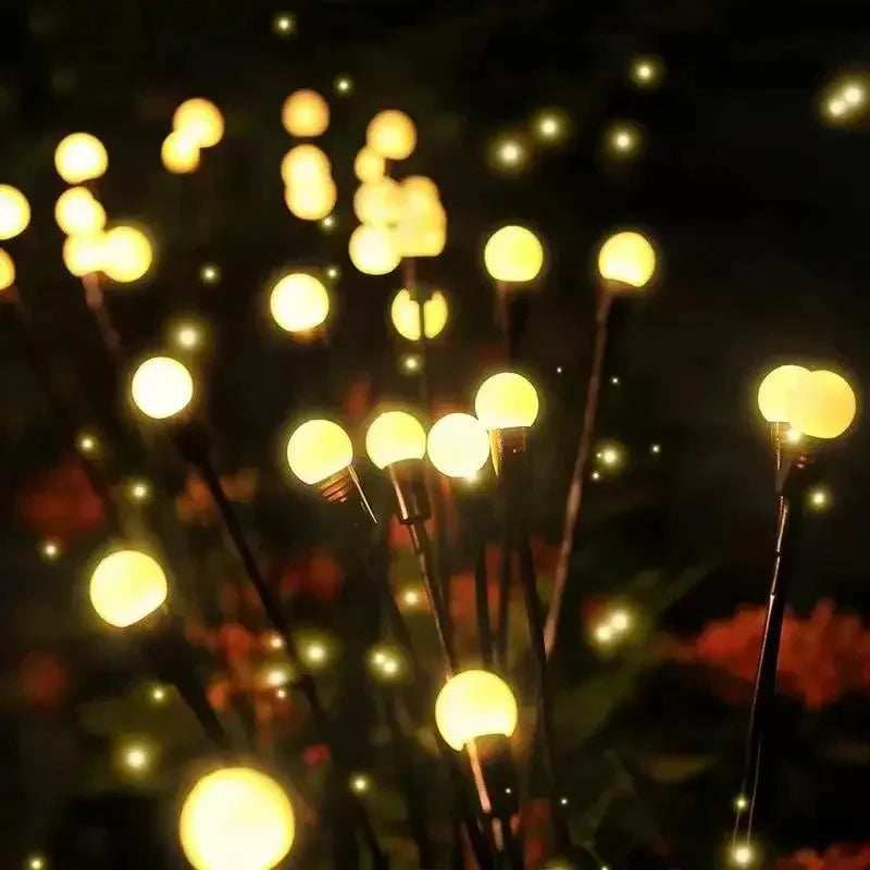 Solar LED pathway lights lining a garden path at night